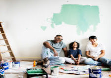 Black family painting house wall